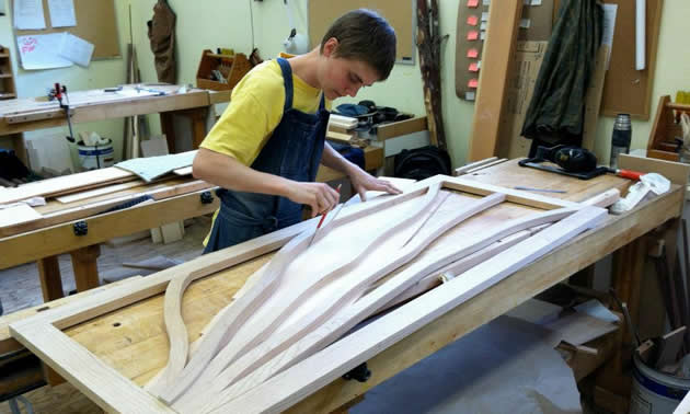 student of the Selkirk College Fine Woodworking Program fine-tuning 