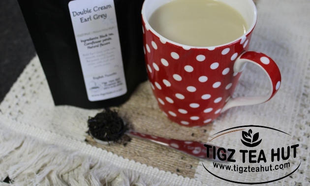 red and white polka dot tea cup with a spoon of tea