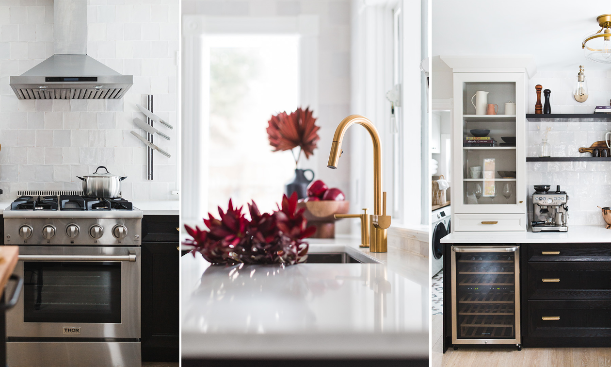 A modern white kitchen with black cabinets.