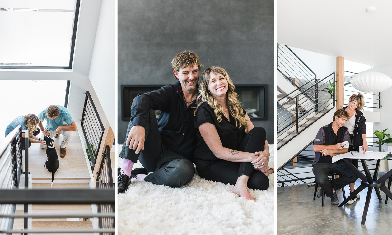 A couple smiles inside of a modern home.