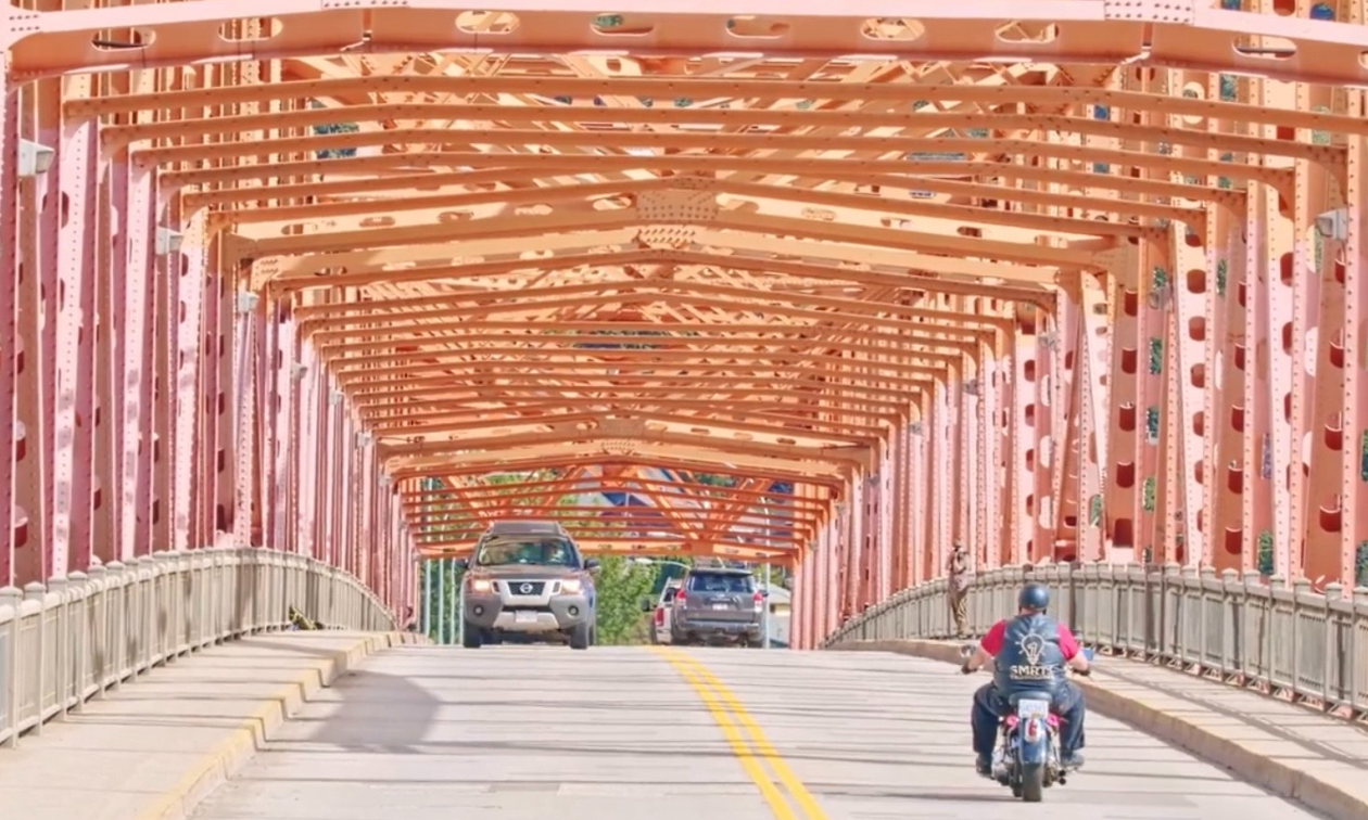 Brad Pommen rides down a highway in Nelson, B.C. on his Harley-Davidson Fat Boy motorcycle. 