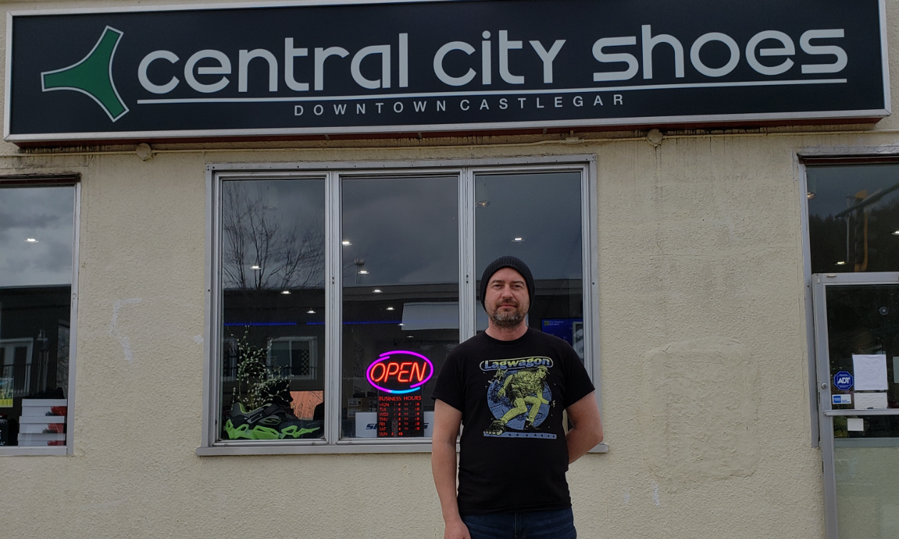 Derrek Kittson stands in front of his business, Central City Shoes. 