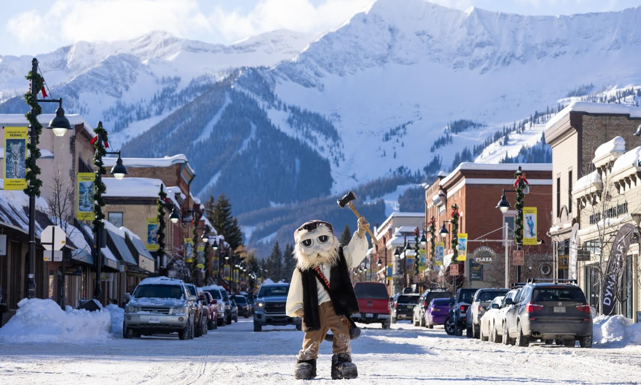 A sasquatch-costumed Taylor Jenkins stands on a snowy main street downtown Fernie. 