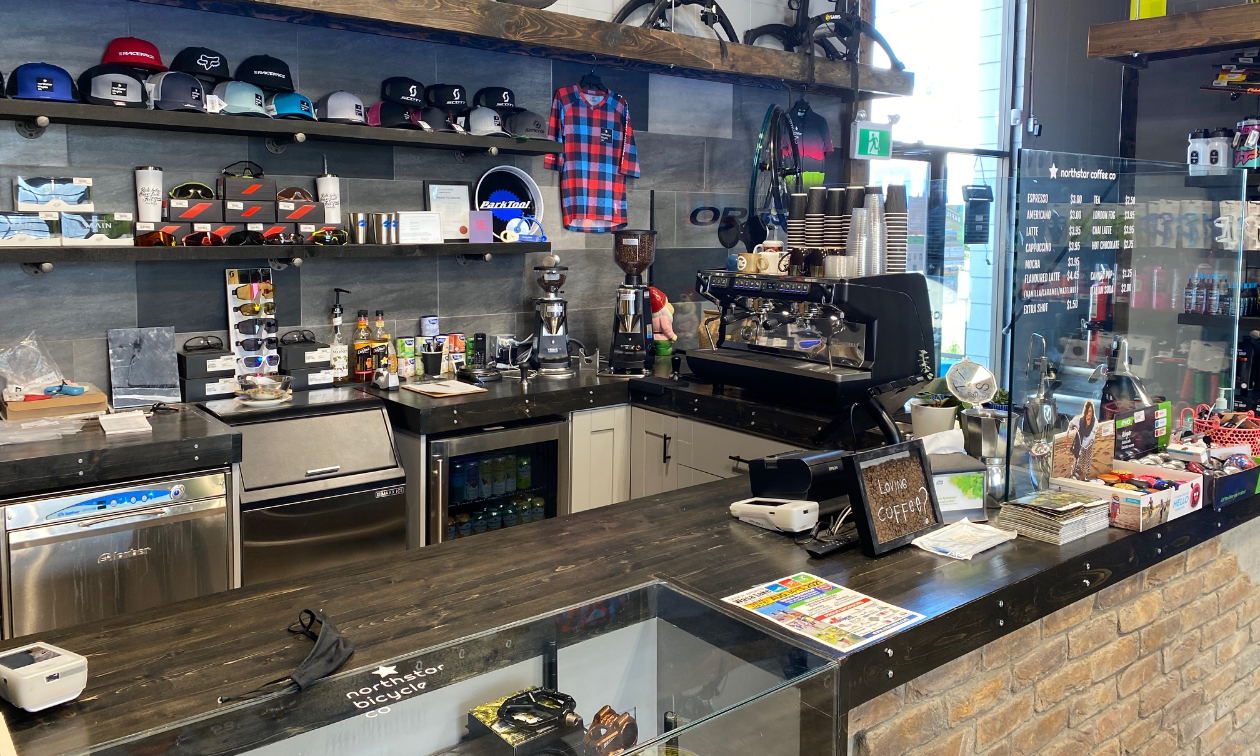 A coffee bar is set up inside a bike shop. 