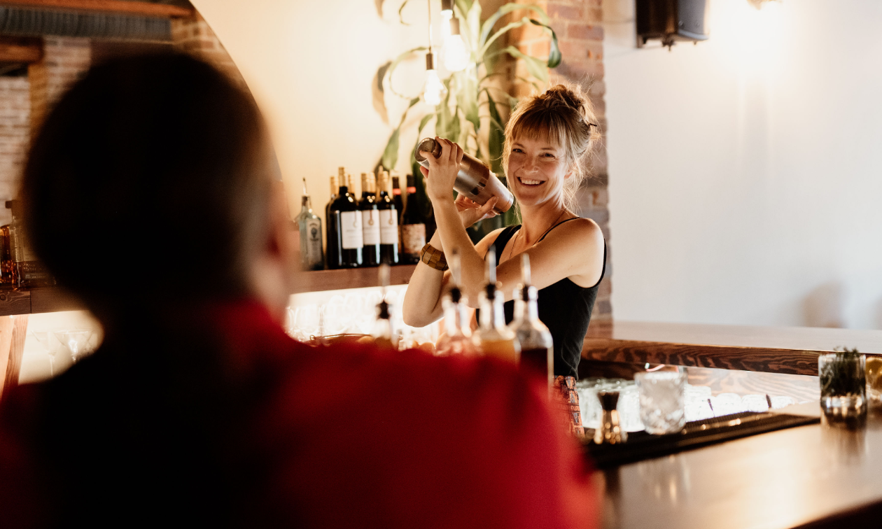 Breanna Fast shakes a drink behind the bar at The Hourglass. 