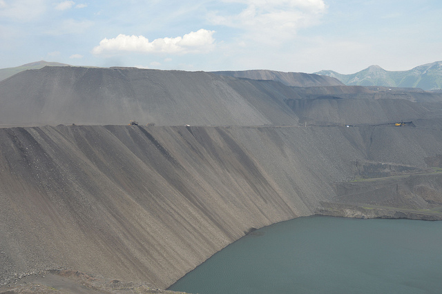 A view of the open pit, with a lake at the bottom.  