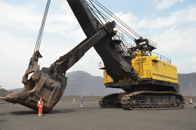 2 children standing in front of the digger that is displayed on the Elkview mine tour hosted by Teck and the Sparwood Chamber of Commerc. 