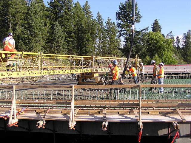 Little Sand Creek Bridge; placing concrete for the bridge deck. The workers place the concrete in front of a deck machine that provides the final deck elevation/grade.
Photo Courtesy Brent Shypitka