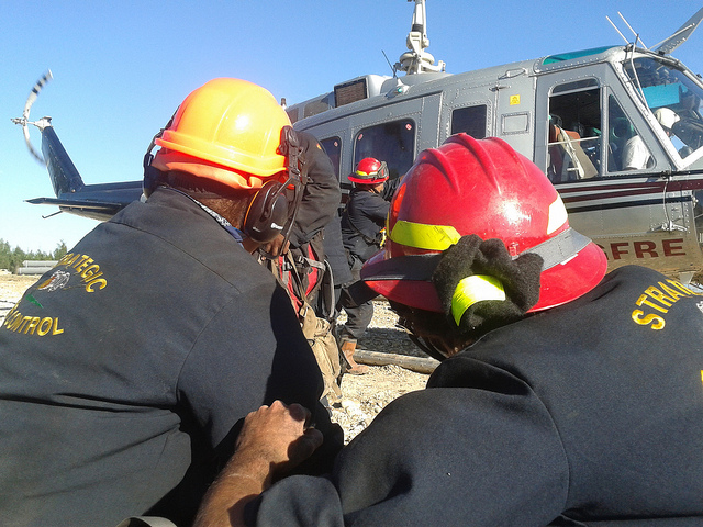 Joe Windels opening helicopter door on way to fight fire in Northwestern Alberta.