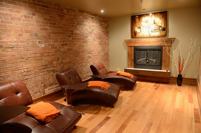 The relaxation room has three comfortable lounge chairs and a fireplace.