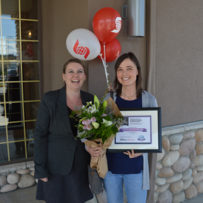 (L to R) Amie Lubbers, sales co-ordinator for Kootenay Business magazine, presents one of three Influential Women In Business awards to Stephanie McGregor, owner of The Paw Shop in Cranbrook. 