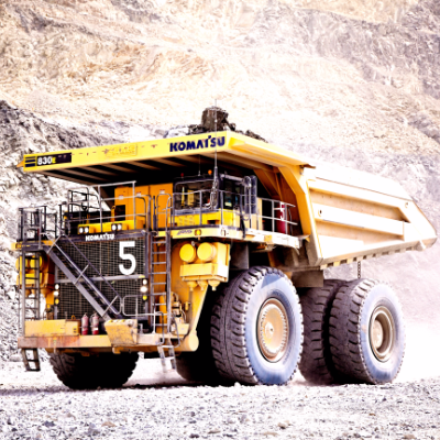 A large Komatsu dump truck works in a quarry 