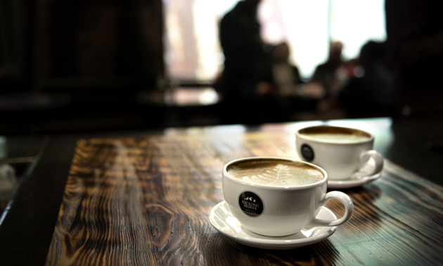 Two cups of coffee on a wooden table in Invermere, B.C.