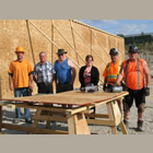 A group of people standing in front of the new Cranbrook Food Bank Warehouse construction site.