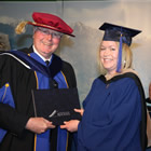 Bachelor of Business Administration student Tamara Eidsness receives her degree from Dr. Nick Rubidge of the COTR.