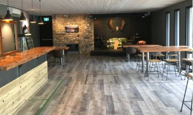 Erie Creek Brewing Company’s lounge features hand-forged stools, one-of-a-kind wood accents and a rock gas fireplace made with stones from the Salmo River.