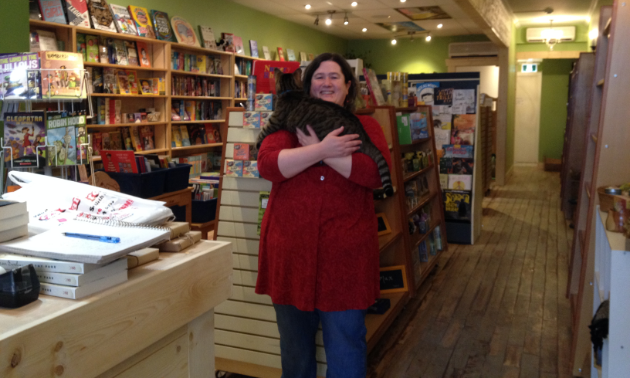 Erin Dalton stands in front of shelves of books.