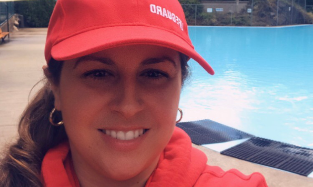 Sonya Pope wears a red lifeguard hat.