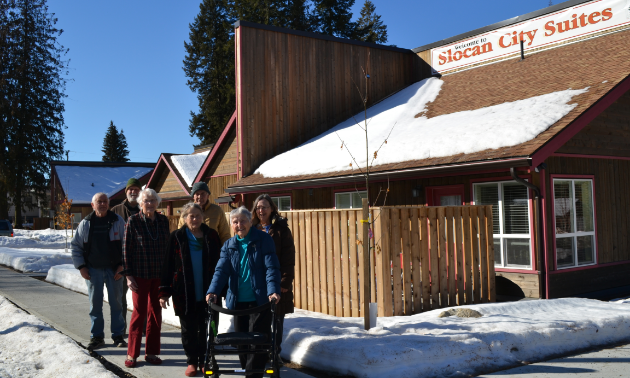 Slocan City Suites tenants stand with 93-year-old Lydia Kania (in front), a formidable fundraiser for both Slocan City Suites and Passmore Lodge. 