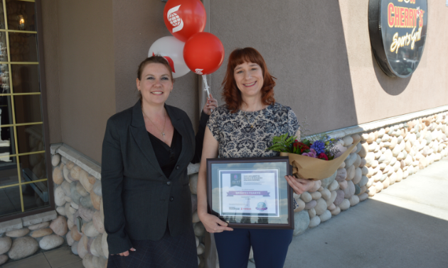 (L to R) Amie Lubbers, sales co-ordinator for Kootenay Business magazine, presents one of three Influential Women In Business awards to Brigitte Franyo, owner/operator of the Snowdrift Cafe in Kimberley. 