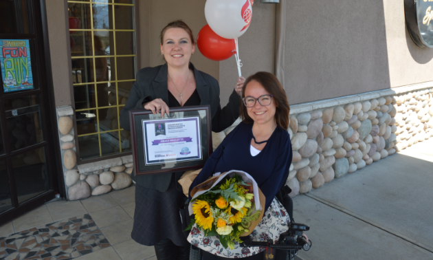(L to R) Amie Lubbers, sales co-ordinator for Kootenay Business magazine, presents one of three Influential Women In Business awards to Grace Brulotte, president and program manager for FIRE: Fernie Adaptive Snow Program. 