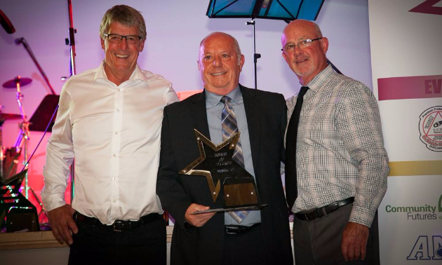 Well-known business owner, Dan Ashman (pictured centre), is dealer principal of AM Ford and was recently awarded Trail's Business Person of the Year Award.