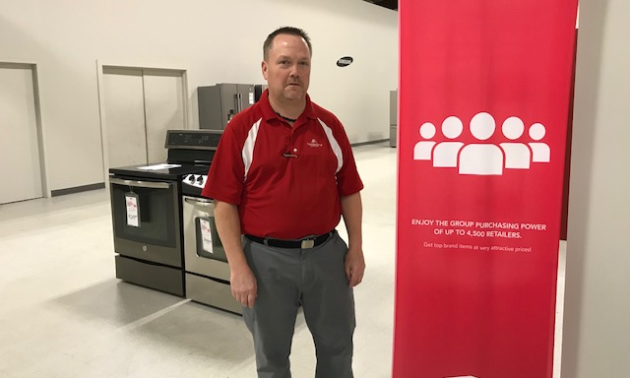 Barry Marsh stands in his store, Bears Furniture and Appliances. 