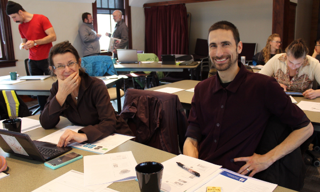 Two students smile while in attendance at an export workshop