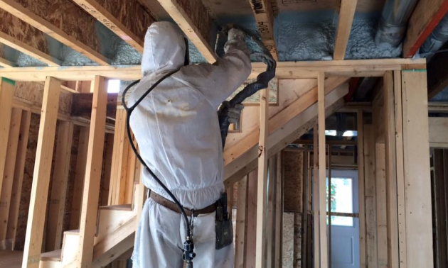 Dan Moberg installs insulation