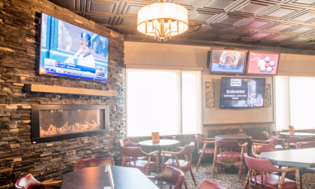 A new fireplace has been installed, surrounded by rock work and new big-screen TVs.