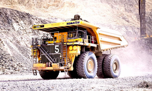 A large Komatsu dump truck works in a quarry 