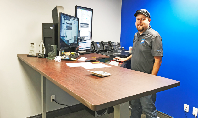 Ryan Doehle stands next to a computer