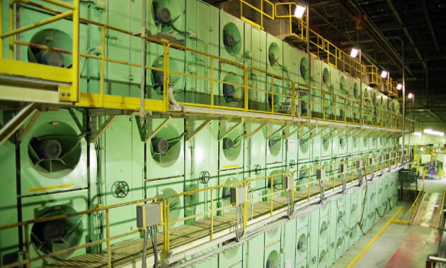 The pulp sheet dryer is shown. The pulp sheet discharged from the third press nip undergoes 27 passes in the Flakt dryer. The Flakt dryer increases the sheet consistency from approximately 46 per cent (containing 54 per cent water) to 90 per cent air dry content (containing 10 per cent water). Residual water in the pulp sheets ensures integrity and prevents cracking due to dryness.