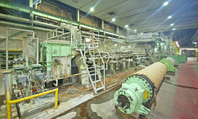 The first section of the pulp machine (wet end) is shown. A dilute slurry of bleached pulp stock is sprayed onto a Fourdrinier forming wire where the water is drained and vacuumed from the pulp fibres, leaving behind a wet web. The water is recycled and used in other stages of the pulp-making process.