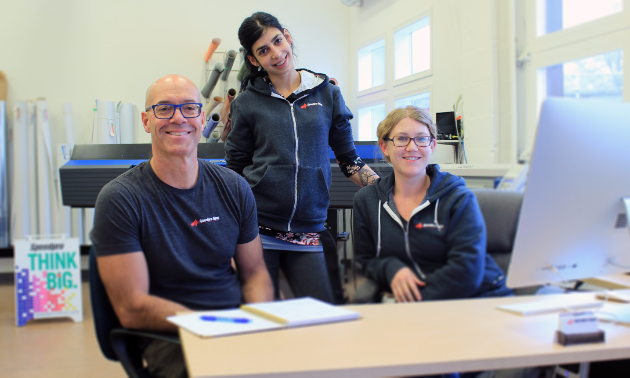 (L to R) Murray Kimber, owner and creative director, Tori Lotecki, client services and production lead, and Stephanie Delnea, senior designer, make up the Speedpro Signs team in Nelson, B.C. 