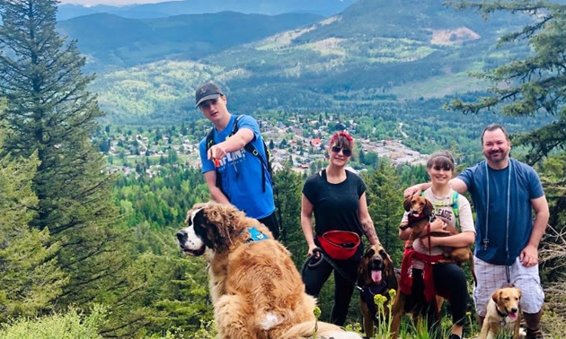 Cooper Baley hiking on a hillside with his family. 