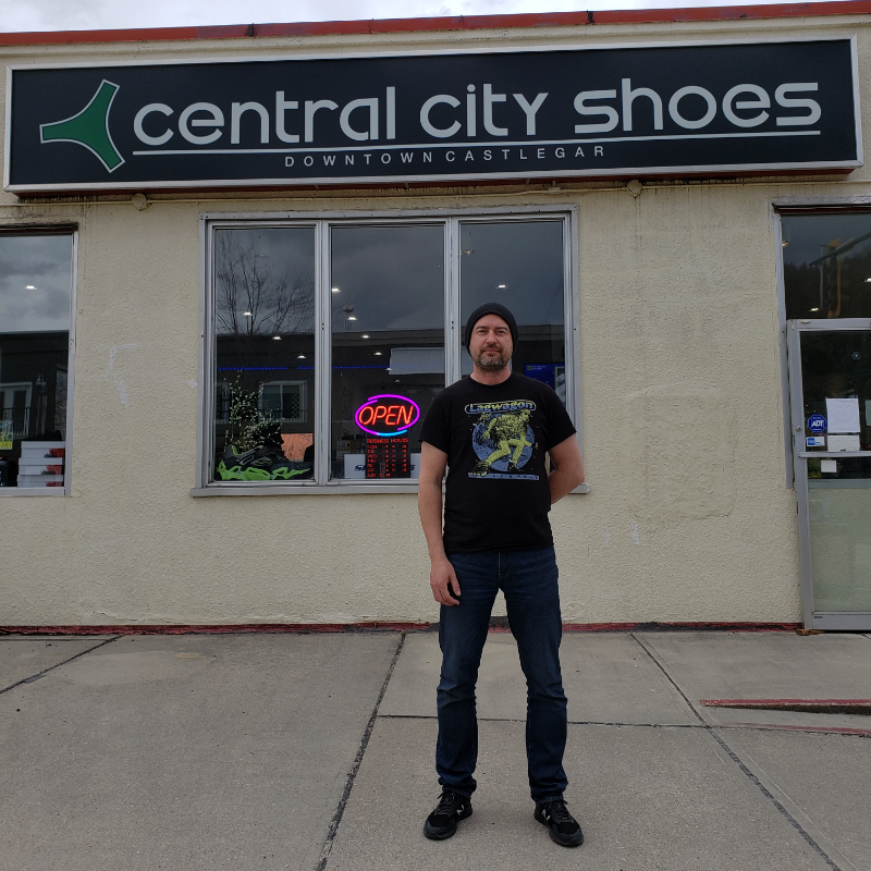 Derrek Kittson stands in front of his business, Central City Shoes. 