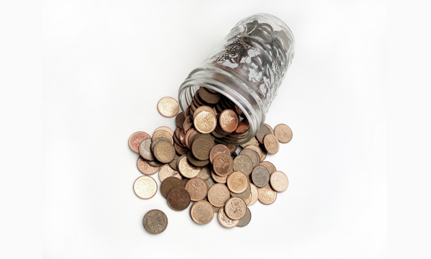 Photo of a jar of pennies spilling