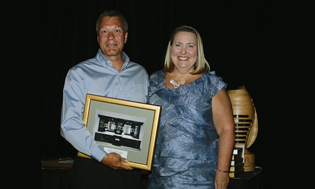 Photo of a man and woman with an award