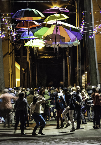 Volunteers and artists celebrate the success of the first Luna Fest by dancing in the alley.