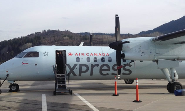 An Air Canada Express airplane on tarmac at airport. 