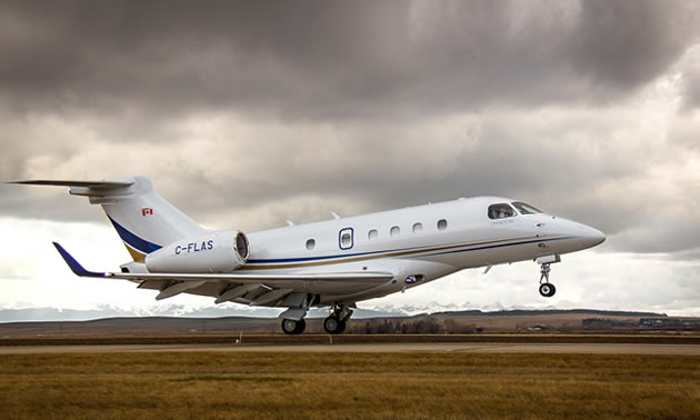 AirSprint plane taking off from runway. 