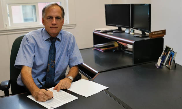 Attorney Alan Burch sitting at his desk. 