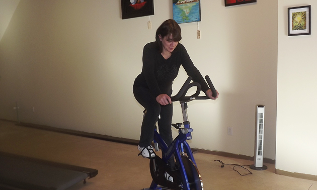 woman on an exercise bike in a gym