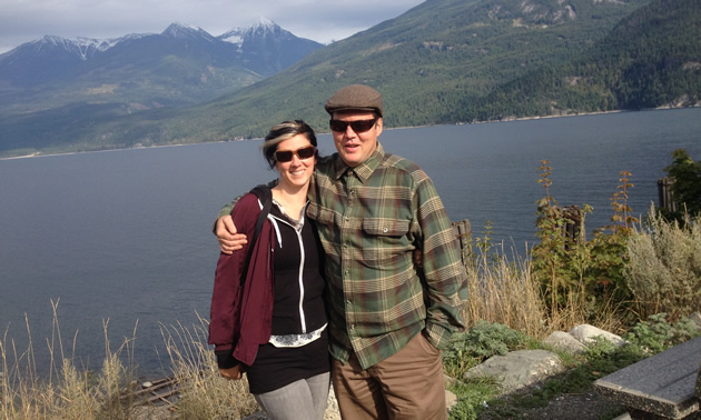 Erin Bruce and Patrick McInnis of Nelson, B.C., on a lakeshore with mountains in the distance