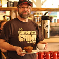 John Snelgrove has a coffee and muffin in the bright atmosphere of Alpine Grind in Rossland, B.C.