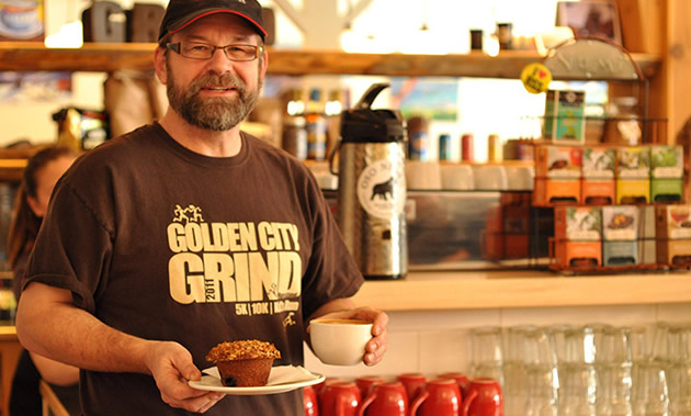 John Snelgrove has a coffee and muffin in the bright atmosphere of Alpine Grind in Rossland, B.C.