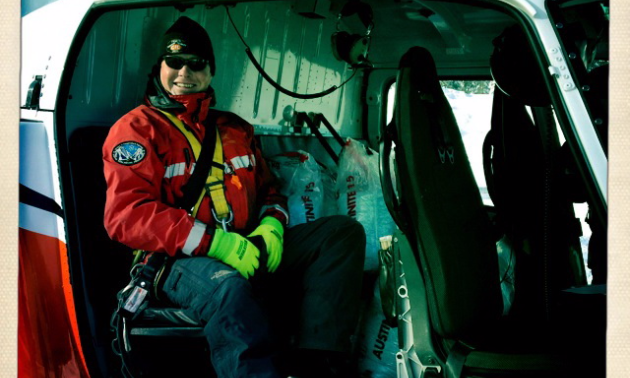 Robb Andersen sits with the explosives in the back seat just before starting a heli-bombing mission.