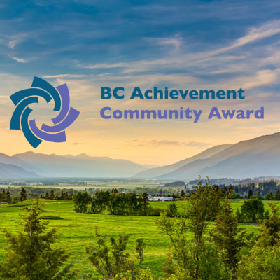Scenic picture of Creston valley, with logo of BC Achievement Foundation Community Awards. 