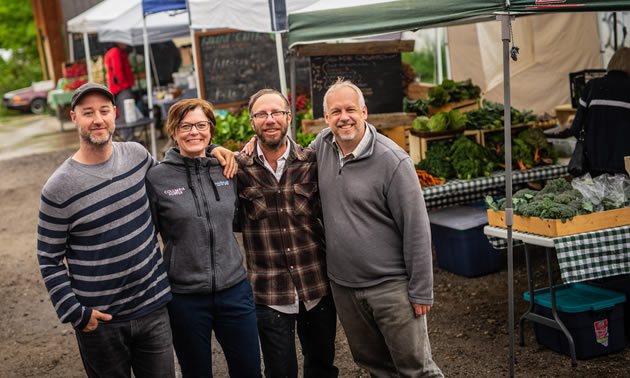 Trust’s contribution to Nutrition Coupon Program reduces wait lists, adds five new markets and feeds 225 more families. In photo (L) to (R) Jesse Woodward, Nelson Market Manager, Eric Struxness, Ravine Creek Farms, Jocelyn Carver, Columbia Basin Trust Board of Director and Peter Leblanc, BCAFM.